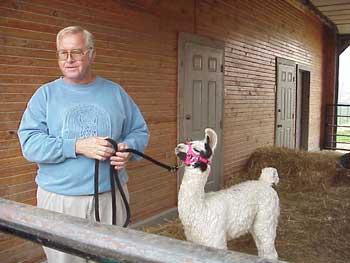 Dr. Riley introduced a baby llama to the children. 