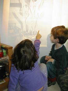 Figure 8. A child points out the shadow lines of the flower to her peer. 