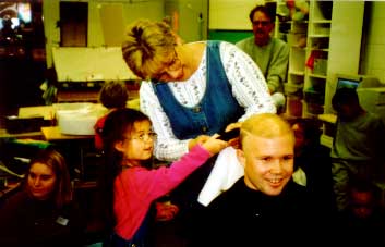 Nancy (4.7 years) took a turn to use the clippers on Chris's hair. 