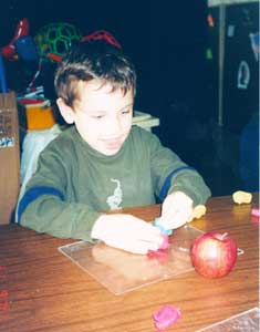 boy molding apple out of clay