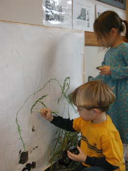 Figures 5 & 6. Children work closely to paint over traced shadow lines. 