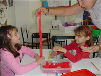 Figure 66. The children used Unifix cubes to figure out the height of the flowers.