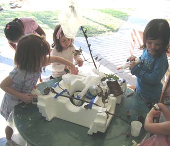 Figure 24. Children use items that blow in the wind to create a trash sculpture.