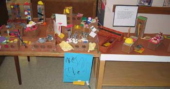 Figure 54. The table display was set up showing the strong houses and levee that the children built.